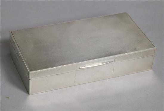 A George VI engine turned silver rectangular cigarette box, John Rose, Birmingham, 1946, 17.2cm.